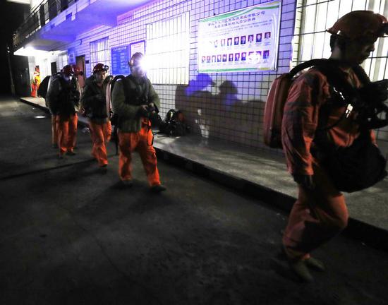 Rescue workers head to the site of a coal mine accident in Chongqing, southwest China, on Friday.