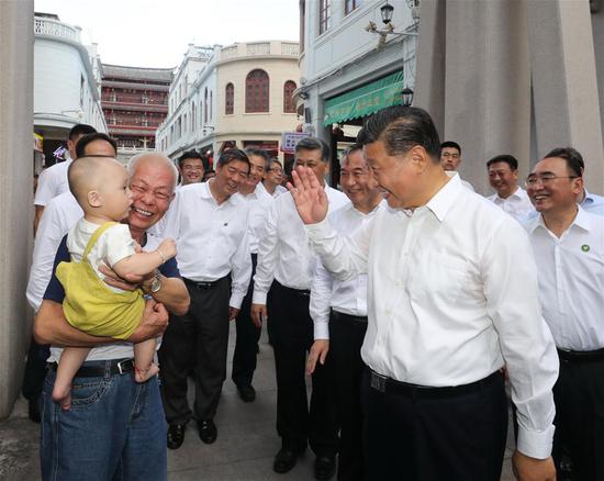 Chinese President Xi Jinping, also general secretary of the Communist Party of China Central Committee and chairman of the Central Military Commission, speaks with people while visiting a street lined with ancient memorial archways in Chaozhou, south China's Guangdong Province, Oct. 12, 2020. Xi on Monday arrived in Guangdong to begin an inspection tour of the province. (Xinhua/Wang Ye)