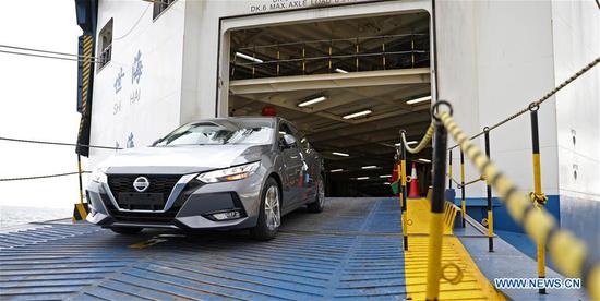 A new vehicle is driven out of a cargo ship at Dalian port in northeast China's Liaoning Provincee, Sept. 24, 2020. Dalian port has been working on developing new shipping routes and growing its throughput as it seeks to further expand its market this year. (Xinhua/Yao Jianfeng)