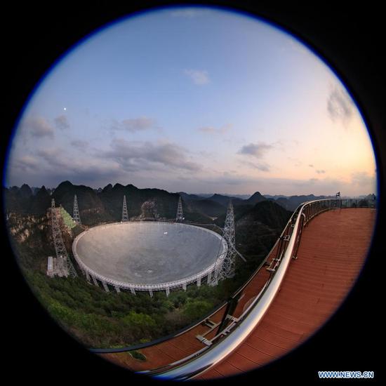 Photo taken on Jan. 8, 2020 shows China's Five-hundred-meter Aperture Spherical Radio Telescope (FAST) under maintenance in southwest China's Guizhou Province. China's FAST, the world's largest single-dish radio telescope, will be available for global service from April 1. The National Astronomical Observatories of China (NAOC) of the Chinese Academy of Sciences, the operator of the telescope, confirmed Monday that scientists across the world can make online appointments for using the device for observation from April 1. An allotted timetable will be available by Aug. 1. (Xinhua/Liu Xu)