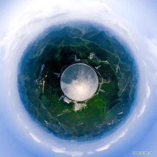 Aerial panoramic photo taken on March 28, 2021 shows China's Five-hundred-meter Aperture Spherical radio Telescope (FAST) under maintenance in southwest China's Guizhou Province. FAST has identified over 300 pulsars so far. Located in a naturally deep and round karst depression in southwest China's Guizhou Province, it officially began operating on Jan. 11, 2020. (Xinhua/Ou Dongqu)