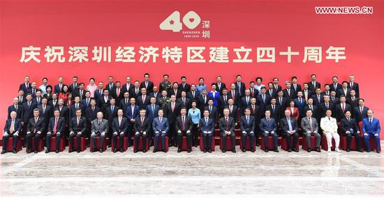 Chinese President Xi Jinping, also general secretary of the Communist Party of China Central Committee and chairman of the Central Military Commission, poses for a group photo with participants of a grand gathering held to celebrate the 40th anniversary of the establishment of the Shenzhen Special Economic Zone in Shenzhen, south China's Guangdong Province, Oct. 14, 2020. Xi attended the gathering and delivered an important speech on Wednesday. (Xinhua/Zhang Ling)