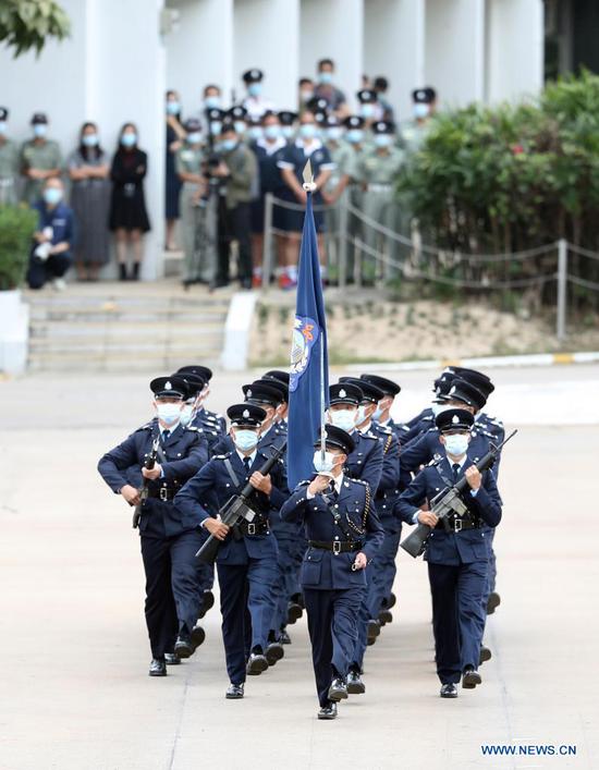 Police officers perform the Chinese-style goose-stepping at the Hong Kong Police College, south China's Hong Kong, April 15, 2021. (Xinhua/Li Gang)