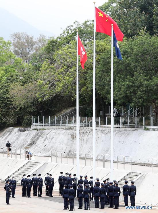 Photo taken on April 15, 2021 shows a flag-raising ceremony held at the Hong Kong Police College in south China's Hong Kong. (Xinhua/Li Gang)