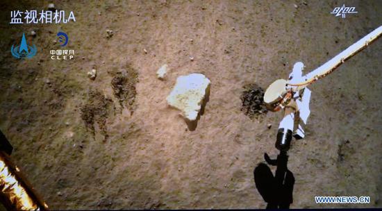 Photo provided by the China National Space Administration (CNSA) shows Chang'e-5 probe gathering samples on the moon on Dec. 2, 2020. China's Chang'e-5 probe has completed sampling on the moon, and the samples have been sealed within the spacecraft, the CNSA announced Thursday morning. (CNSA/Handout via Xinhua)