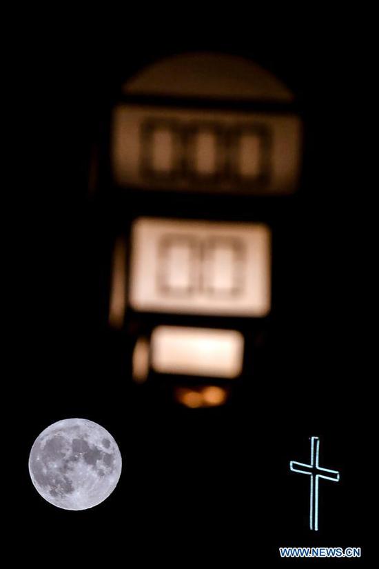 A full moon rises over a church in old town of Ohrid, North Macedonia, Aug. 3, 2020. (Photo by Tomislav Georgiev/Xinhua)