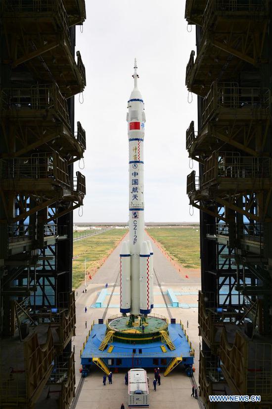 The combination of the Shenzhou-12 manned spaceship and a Long March-2F carrier rocket is being transferred to the launching area of Jiuquan Satellite Launch Center in northwest China, June 9, 2021. The combination of the Shenzhou-12 manned spaceship and a Long March-2F carrier rocket has been transferred to the launching area, the China Manned Space Agency (CMSA) said Wednesday. The facilities and equipment at the launch site are in good condition, and various pre-launch function checks and joint tests will be carried out as planned, said the CMSA. (Photo by Wang Jiangbo/Xinhua)