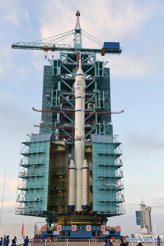 Photo shows the combination of the Shenzhou-12 manned spaceship and a Long March-2F carrier rocket after it was transferred to the launching area of Jiuquan Satellite Launch Center in northwest China, June 9, 2021. The combination of the Shenzhou-12 manned spaceship and a Long March-2F carrier rocket has been transferred to the launching area, the China Manned Space Agency (CMSA) said Wednesday. The facilities and equipment at the launch site are in good condition, and various pre-launch function checks and joint tests will be carried out as planned, said the CMSA. (Photo by Wang Jiangbo/Xinhua)