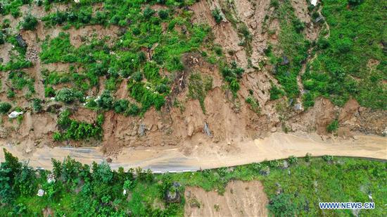 Trapped people are transferred by a bulldozer in Wudu District of Longnan City, northwest China's Gansu Province, Aug. 17, 2020. Week-long torrential rains in Gansu Province have led to a tributary of Yangtze River flowing above danger-level as local authorities battle various rain-triggered disasters including mountain torrents, landslides and mudflows. By Monday, rains damaged 3,303 km of roads in the city of Longnan, disrupting traffic on 497 roads. More than 38,000 people have been relocated in Longnan. (Xinhua/Chen Bin)