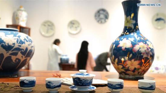 Visitors look at porcelains during the 2018 China Jingdezhen International Ceramics Exposition in Jingdezhen, east China's Jiangxi Province, Oct. 18, 2018. The 2018 China Jingdezhen International Ceramics Exposition attracted over 3,000 exhibitors from nearly 500 global ceramics enterprises. (Xinhua/Hu Chenhuan)