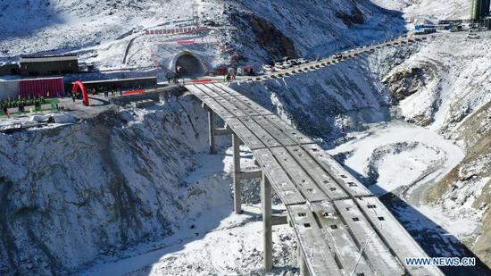 Aerial photo taken on March 2, 2021 shows an entrance to the Dongshan tunnel along the national highway No. 213 in Yugur Autonomous County of Sunan of northwest China's Gansu Province. The 3,639-meter Dongshan tunnel at an average altitude of 3,850 meters was drilled through on Tuesday. It is a critical project for national highway No. 213 that connects Sunan to Qilian County in Qinghai Province, also in northwest China. (Xinhua/Chen Bin)