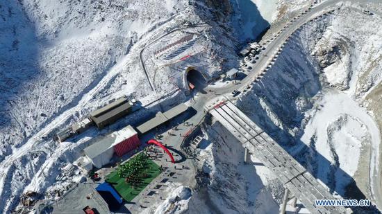 Aerial photo taken on March 2, 2021 shows an entrance to the Dongshan tunnel along the national highway No. 213 in Yugur Autonomous County of Sunan of northwest China's Gansu Province. The 3,639-meter Dongshan tunnel at an average altitude of 3,850 meters was drilled through on Tuesday. It is a critical project for national highway No. 213 that connects Sunan to Qilian County in Qinghai Province, also in northwest China. (Xinhua/Chen Bin)