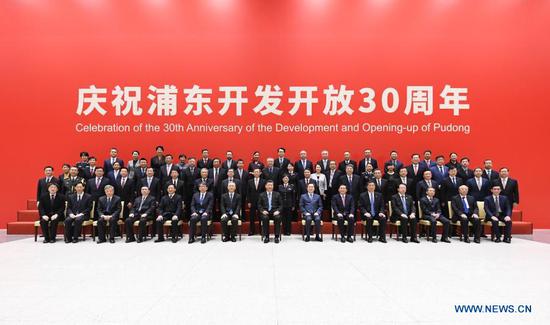 Chinese President Xi Jinping, also general secretary of the Communist Party of China Central Committee and chairman of the Central Military Commission, poses for a group photo with participants of a grand gathering that celebrates the 30th anniversary of the development and opening-up of Shanghai's Pudong in Shanghai, east China, Nov. 12, 2020. Xi delivered an important speech at the event. (Xinhua/Shen Hong)