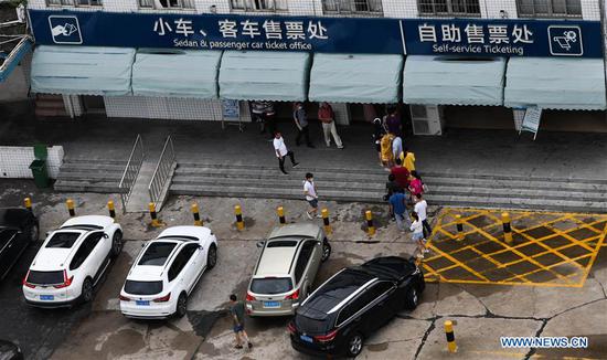 Passengers line up to buy tickets at Xiuyinggang Ferry Terminal in Haikou, south China's Hainan Province, Aug. 2, 2020. Typhoon Sinlaku, the third one of this year, is heading northwestward at about 15 km per hour and is expected to land on the northern coast of Vietnam at around Sunday noon, China's National Meteorological Center said. (Xinhua/Yang Guanyu)