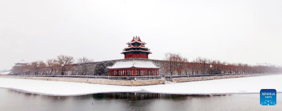 Photo taken with a mobile phone shows a turret of the Palace Museum amid snow in Beijing, capital of China, Feb. 13, 2022. A snowfall hit Beijing on Sunday. (Xinhua/Pan Xu)