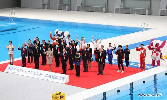 Guests pose for photos during the Grand Opening Ceremony of Tokyo Aquatics Centre in Tokyo, Japan, Oct. 24, 2020. Tokyo Aquatics Centre will be used for the Tokyo Olympic and Paralympic swimming games. The ceremony, which was planned to be held in March this year, was postponed due to the COVID-19. (Xinhua/Du Xiaoyi)