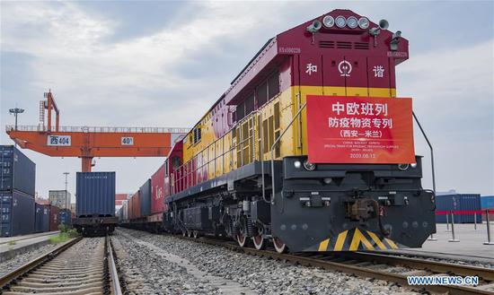 A China-Europe freight train with 45 compartments of anti-epidemic supplies leaves the Xinzhu Railway Station in Xi'an, northwest China's Shaanxi Province, on Aug. 12, 2020, to head for Italy's Milan. The shipment includes 368,300 masks and 94.9 tonnes of melt-blown non-woven fabric, an essential material for manufacturing medical masks. (Photo by Yuan Jingzhi/Xinhua)