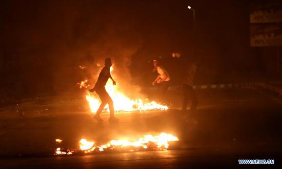 Protesters clash with Israeli soldiers at Huwwara checkpoint near the West Bank city of Nablus, on May 10, 2021. Tension between Israelis and Palestinians has been flaring up over the past few days amid the escalating violence in East Jerusalem between Palestinian demonstrators and Israeli forces. (Photo by Ayman Nobani/Xinhua)