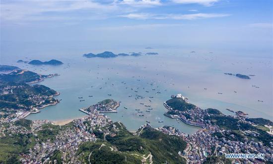 Aerial photo shows fishing boats departing from a port in Wenling, east China's Zhejiang Province, Sept. 16, 2020. Fishing boats departed from ports in Zhejiang Province at noon on Wednesday, marking the end of the four-and-a-half month summer fishing ban in the East China Sea. (Photo by Zhu Haiwei/Xinhua)