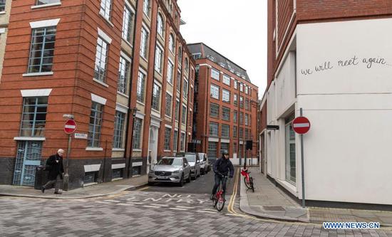 People are seen at Queen Elizabeth Street in London, Britain, on Jan. 5, 2021. British Prime Minister Boris Johnson announced Monday that England will enter a national lockdown from midnight, the third of its kind since the coronavirus pandemic began in the country. (Xinhua/Han Yan)