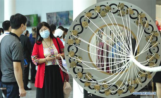 Visitors tour the exhibition area of the 8th China Taobao Village Summit Conference in Suning County, north China's Hebei Province, Sept. 26, 2020. The 8th China Taobao Village Summit Conference was held in Suning on Saturday. The Taobao Villages are rural e-commerce hubs that feature Alibaba's logistics, service and training to encourage farmers to engage in online sales of farm produce and local specialties. With 17 Taobao Villages and 9 Taobao Towns, Suning has a total of over 21,000 e-commerce online stores, achieving a yearly revenue of nearly 10 billion yuan (about 1.47 billion U.S. dollars). (Xinhua/Zhu Xudong)