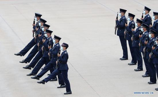 Police officers perform the Chinese-style goose-stepping at the Hong Kong Police College, south China's Hong Kong, April 15, 2021. (Xinhua/Li Gang)