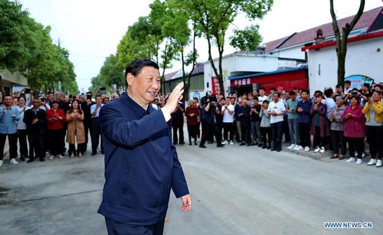 Chinese President Xi Jinping, also general secretary of the Communist Party of China Central Committee and chairman of the Central Military Commission, waves to villagers while inspecting Zouzhuang Village, Xichuan County, Nanyang, central China's Henan Province, May 13, 2021. (Xinhua/Ju Peng)