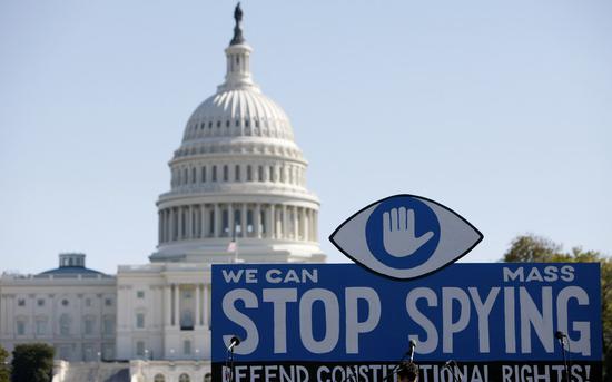 File photo taken on Oct. 26, 2013 shows a huge slogan board stands in front of the U.S. Capitol building during a protest against government surveillance in Washington D.C., the United Sates. (Xinhua/Fang Zhe)