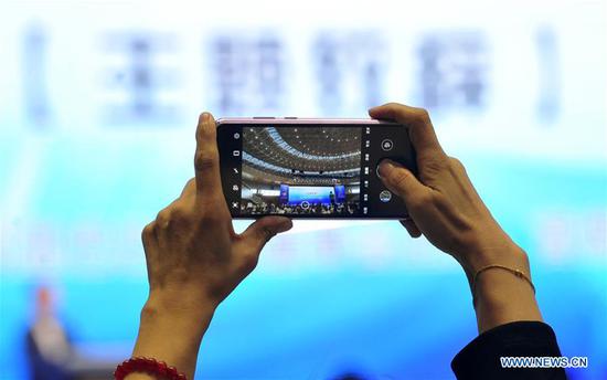 A visitor takes photos of the site of the 8th China Taobao Village Summit Conference in Suning County, north China's Hebei Province, Sept. 26, 2020. The 8th China Taobao Village Summit Conference was held in Suning on Saturday. The Taobao Villages are rural e-commerce hubs that feature Alibaba's logistics, service and training to encourage farmers to engage in online sales of farm produce and local specialties. With 17 Taobao Villages and 9 Taobao Towns, Suning has a total of over 21,000 e-commerce online stores, achieving a yearly revenue of nearly 10 billion yuan (about 1.47 billion U.S. dollars). (Xinhua/Zhu Xudong)