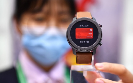 A staff member displays a mobile payment terminal for digital Chinese yuan (e-CNY) at the first China International Consumer Products Expo in Haikou, capital of south China's Hainan Province, May 8, 2021. (Xinhua/Guo Cheng)