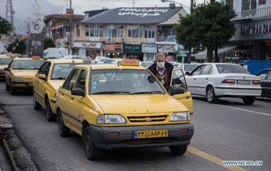 A taxi driver wearing a face mask waits for passengers in Tonekabon, Iran, on Nov. 24, 2020. The total number of COVID-19 cases in Iran surged to 880,542, while the death toll climbed by 483 to 45,738, said Sima Sadat Lari, spokeswoman for the Iranian Ministry of Health and Medical Education. A total of 617,715 people in Iran have recovered from the disease, while 5,824 others remained in intensive care units, Lari added. (Photo by Ahmad Halabisaz/Xinhua)