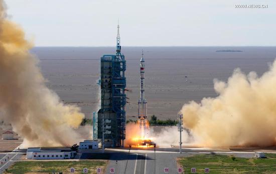 The crewed spacecraft Shenzhou-12, atop a Long March-2F carrier rocket, is launched from the Jiuquan Satellite Launch Center in northwest China's Gobi Desert, June 17, 2021. (Xinhua/Li Gang)