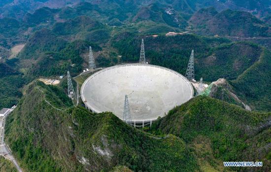 Photo taken on Jan. 11, 2020 shows China's Five-hundred-meter Aperture Spherical Radio Telescope (FAST) under maintenance in southwest China's Guizhou Province. China's FAST, the world's largest single-dish radio telescope, will be available for global service from April 1. The National Astronomical Observatories of China (NAOC) of the Chinese Academy of Sciences, the operator of the telescope, confirmed Monday that scientists across the world can make online appointments for using the device for observation from April 1. An allotted timetable will be available by Aug. 1. (Xinhua/Liu Xu)