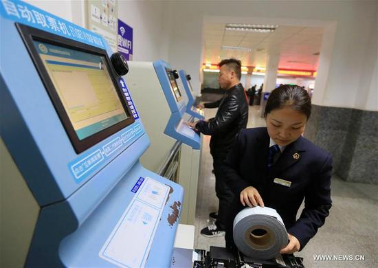 A staff member debugs a ticket vending machine at Kaili railway station in Kaili City, southwest China's Guizhou Province, Jan. 2, 2018. Train tickets for the Spring Festival travel rush go on sale on Jan. 3, 2018. China's transport system is often put to the test during the annual travel rush around the Spring Festival. The period is called "chunyun," which literally means "Spring Festival transport." During Spring Festival, which falls on Feb. 15 this year, hundreds of millions of Chinese will go back to their hometowns to celebrate the most important holiday of the year with their families. (Xinhua/Wu Jibin)
