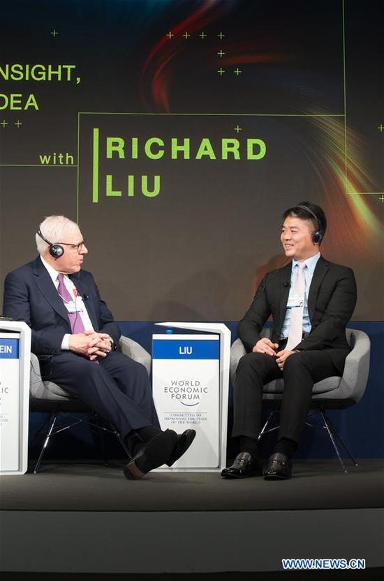 Richard Liu (R), chairman and CEO of JD.com, attends a dialogue with David Mark Rubinstein, co-founder and co-chief executive officer of The Carlyle Group, during the 48th annual meeting of the World Economic Forum (WEF) in Davos, Switzerland, Jan. 24, 2018.