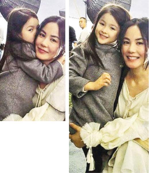 王菲抱起小女孩一起玩