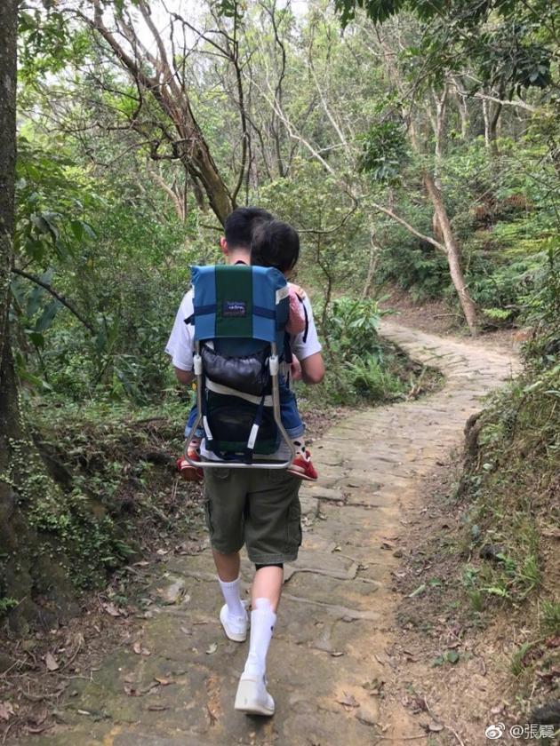 张震背着女儿登山