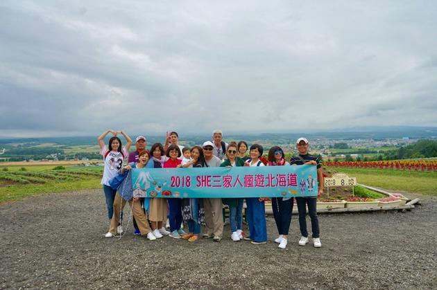h.e结伴游北海道 三家人集体旅行开心举横幅