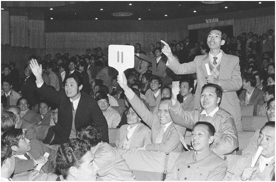 1987年12月1日下午，深圳房地产公司经理骆锦星（举11号牌者）以525万元的价格，获得市政府拍卖的一块住宅用地的使用权。新华社记者 程至善 摄（传真照片）