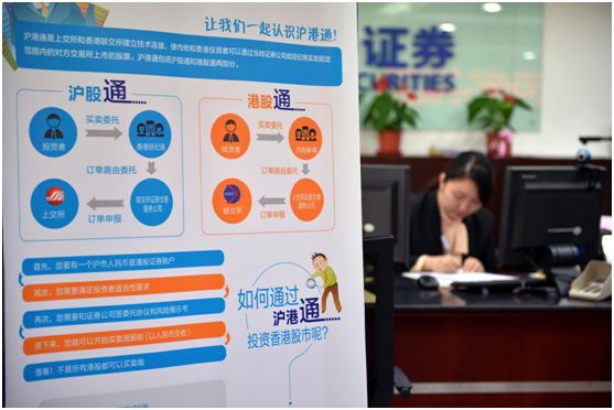 2014年11月17日，沪港通开通仪式在上海和香港交易所同时举行。图为北京复兴门外大街一家证券公司营业部内的沪港通宣传海报（2014年11月17日摄）。新华社记者 李鑫 摄