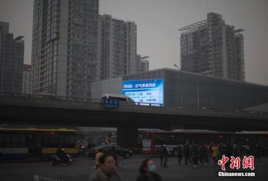 资料图：3月20日，北京市民在雾霾中出行。当日，京津冀环境气象预报预警中心发布的北京地区空气污染气象条件预报显示，北京当天白天大部分地区空气污染气象条件等级为3-4级。 中新社记者 刘关关 摄