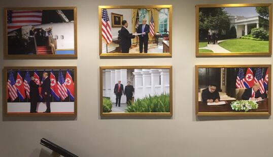  白宫西厢办公室墙壁上挂满了“金特会”相关的照片。