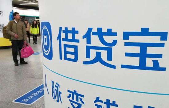 2016年1月8日，北京，一行人从借贷宝logo招牌旁经过。  视觉中国 资料图