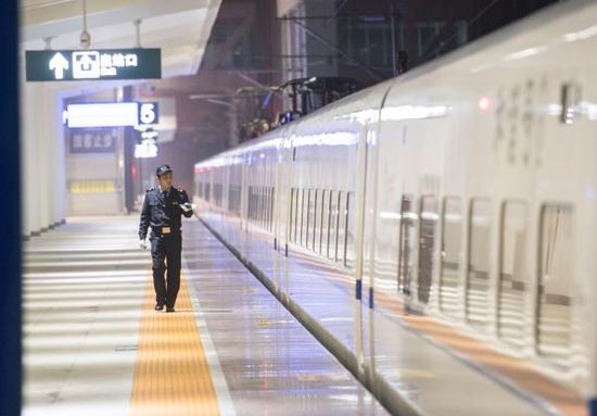 1月12日，在重庆万州北火车站站台上，工作人员对万州始发的首趟春运高铁动车进行检查。新华社发