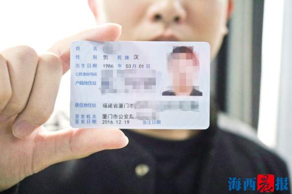 申请人展示已到手的居住证。记者 陈小斌 摄