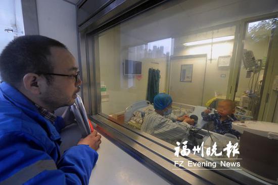 叶鑫鹏爸爸在抽取干细胞前来到移植仓窗口看望儿子。