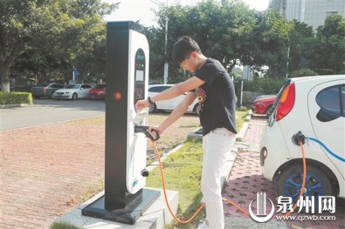 市民使用充电桩为电动汽车充电