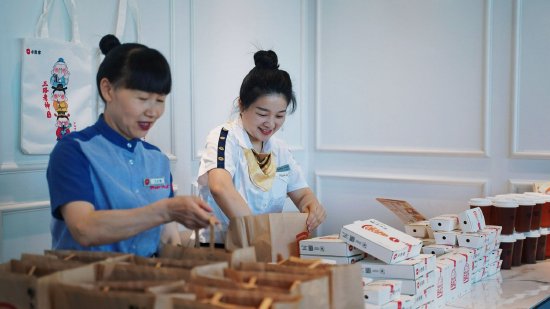 [图注：餐厅员工为学生们准备“能量包”]