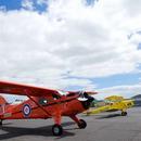  Antique aircraft flying in the blue sky is a living aviation history