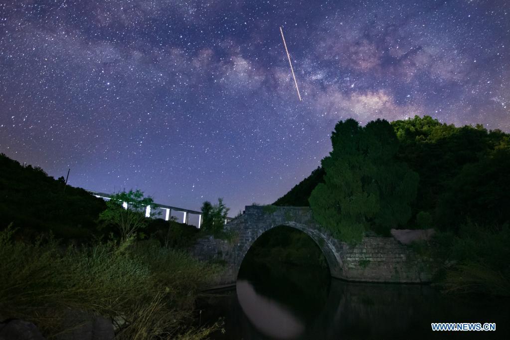 The Mengjia ancient bridge, built in 1882, is pictured along with the Yinpo River grand bridge of the Guiyang-Nanning high-speed railway (in the distance) in Dushan County, southwest China's Guizhou Province, June 6, 2021. (Xinhua/Liu Xu)